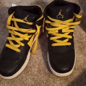 Black and yellow Nike Jordan's
